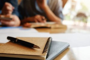 education-concept-student-studying-brainstorming-campus-concept-close-up-students-discussing-their-subject-books-textbooks-selective-focus_1418-626
