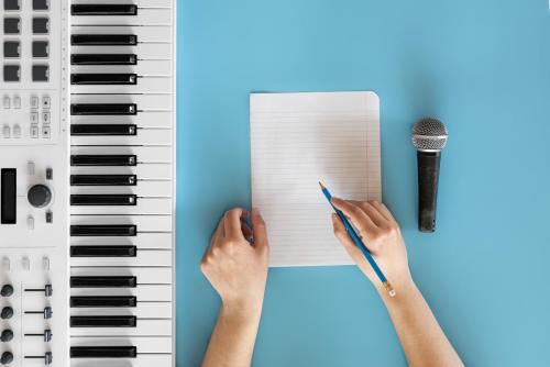 musical-keys-microphone-blank-paper-blue-background